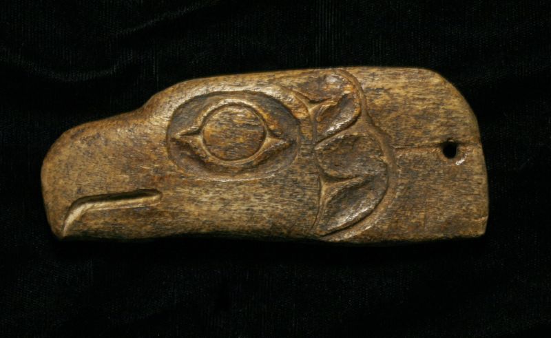 Carved bone shaman's amulet depicting an eagle's head