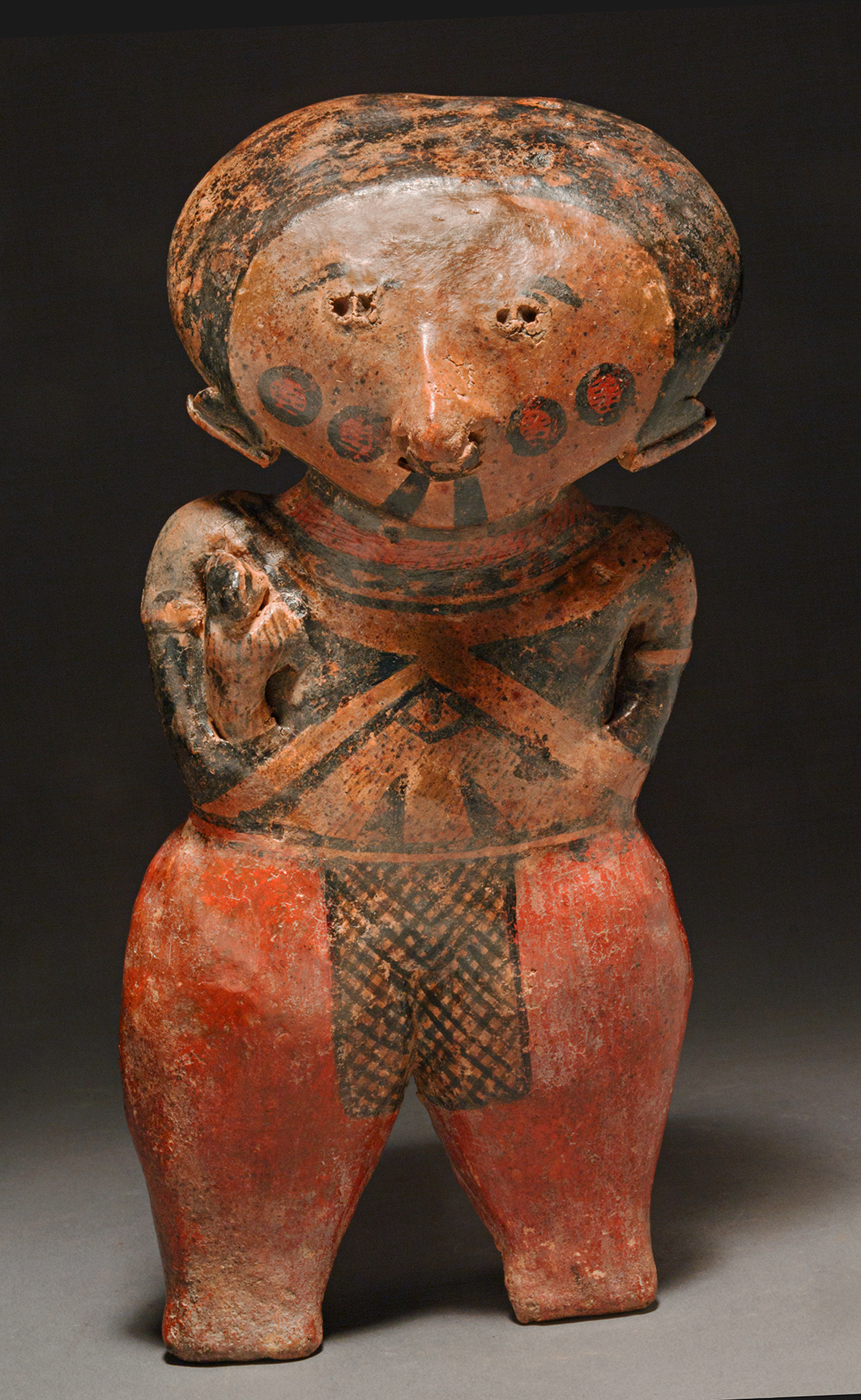 Chinesco standing female holding a baby 1